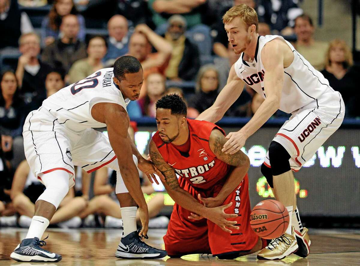 UConn’s Lasan Kromah, left, Niels Giffey and the rest of the Huskies will have opponents on their knees this season, just like Detroit’s Juwan Howard Jr. was on Thursday night, according to Register sports columnist Chip Malafronte.