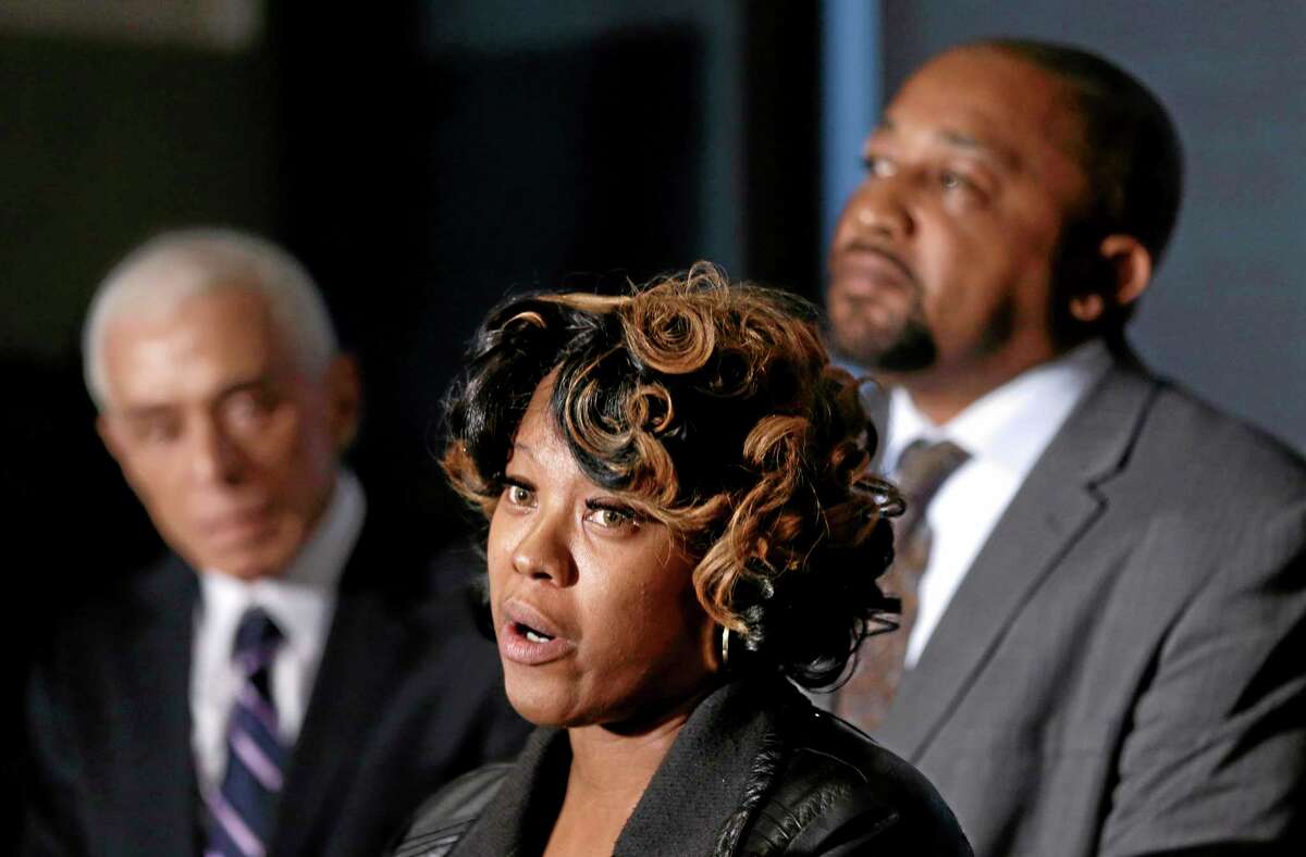 Monica McBride, center, and Walter Ray Simmons, right, the parents of Renisha McBride address the media with attorney Gerald Thurswell, left, during a news conference in Southfield, Mich., Friday, Nov. 15, 2013. Their daughter was shot on Nov. 2 in the face on Theodore P. Wafer's front porch in Dearborn Heights. (AP Photo/Carlos Osorio)