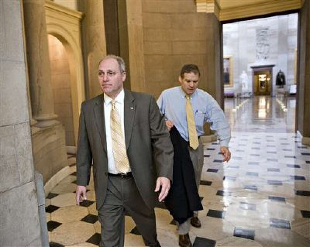 Rep. Steve Scalise, R-La., left, and Rep. Jim Jordan, R-Ohio, leave the office of House Speaker John Boehner, R-Ohio on Friday before a vote on Obamacare.
