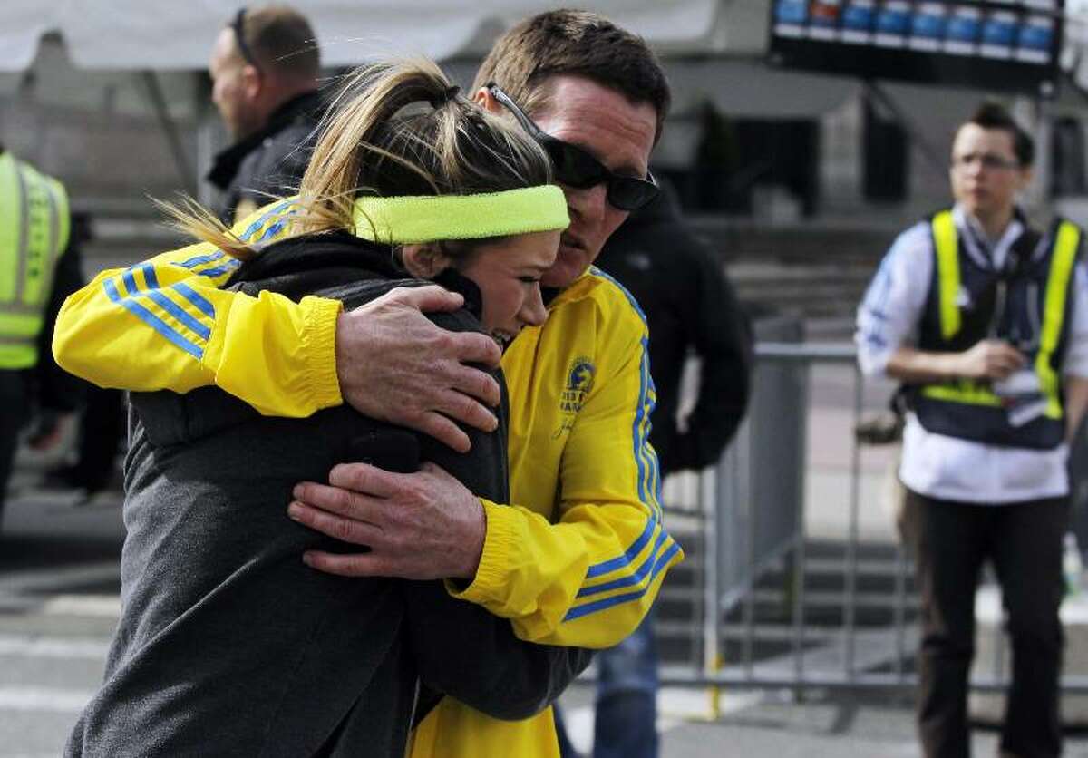 A woman is comforted by a man near a triage tent after explosions went off at the 117th Boston Marathon in Boston, Massachusetts. (Jessica Rinaldi/Reuters)