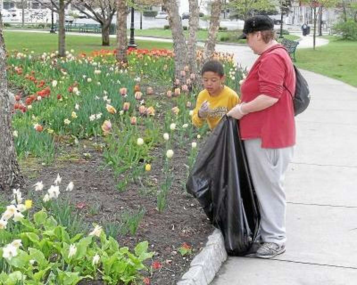 Residents work during a 2012 Earth Day cleanup. -- Register Citizen File photo.