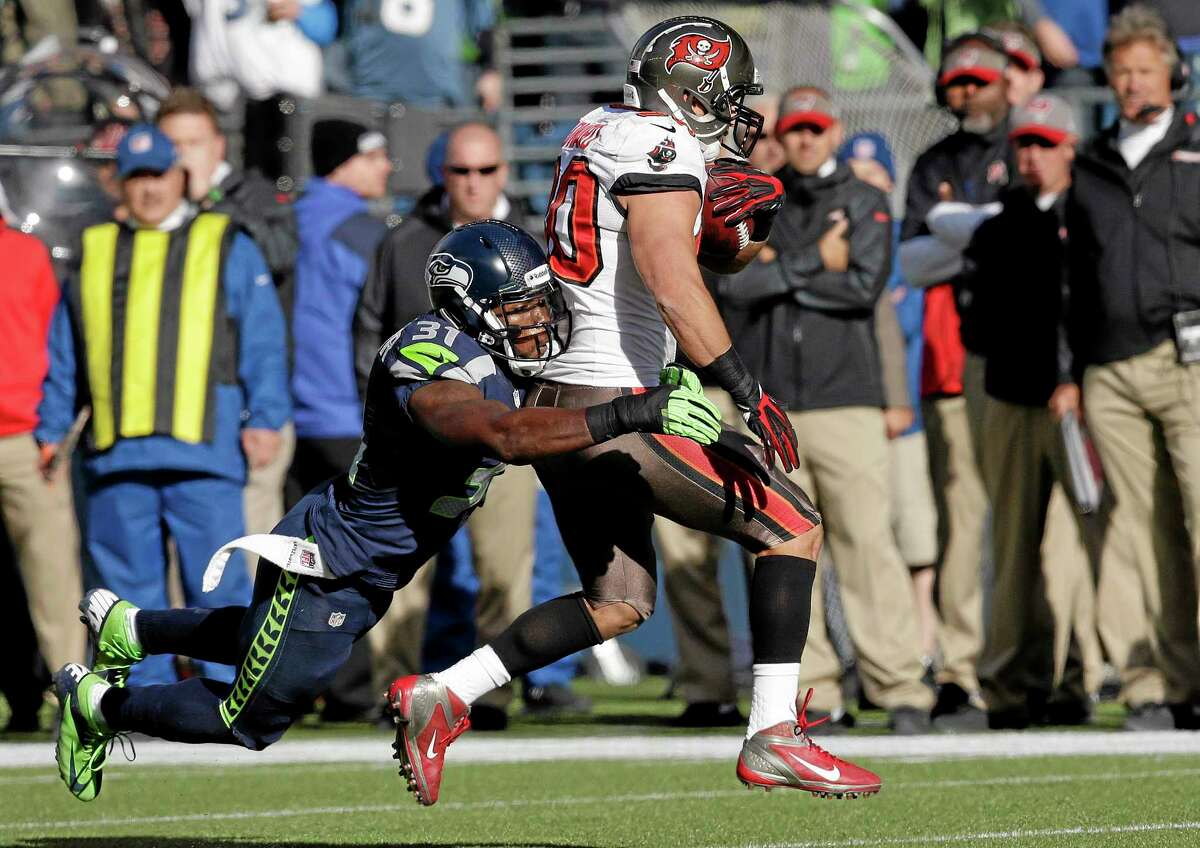 Tampa Bay Buccaneers running back Brian Leonard gets tackled by Seahawks strong safety Kam Chancellor during the first half of a Nov. 3 game in Seattle. The Register’s Dan Nowak feels Leonard is a prime pickup if you need a running back.