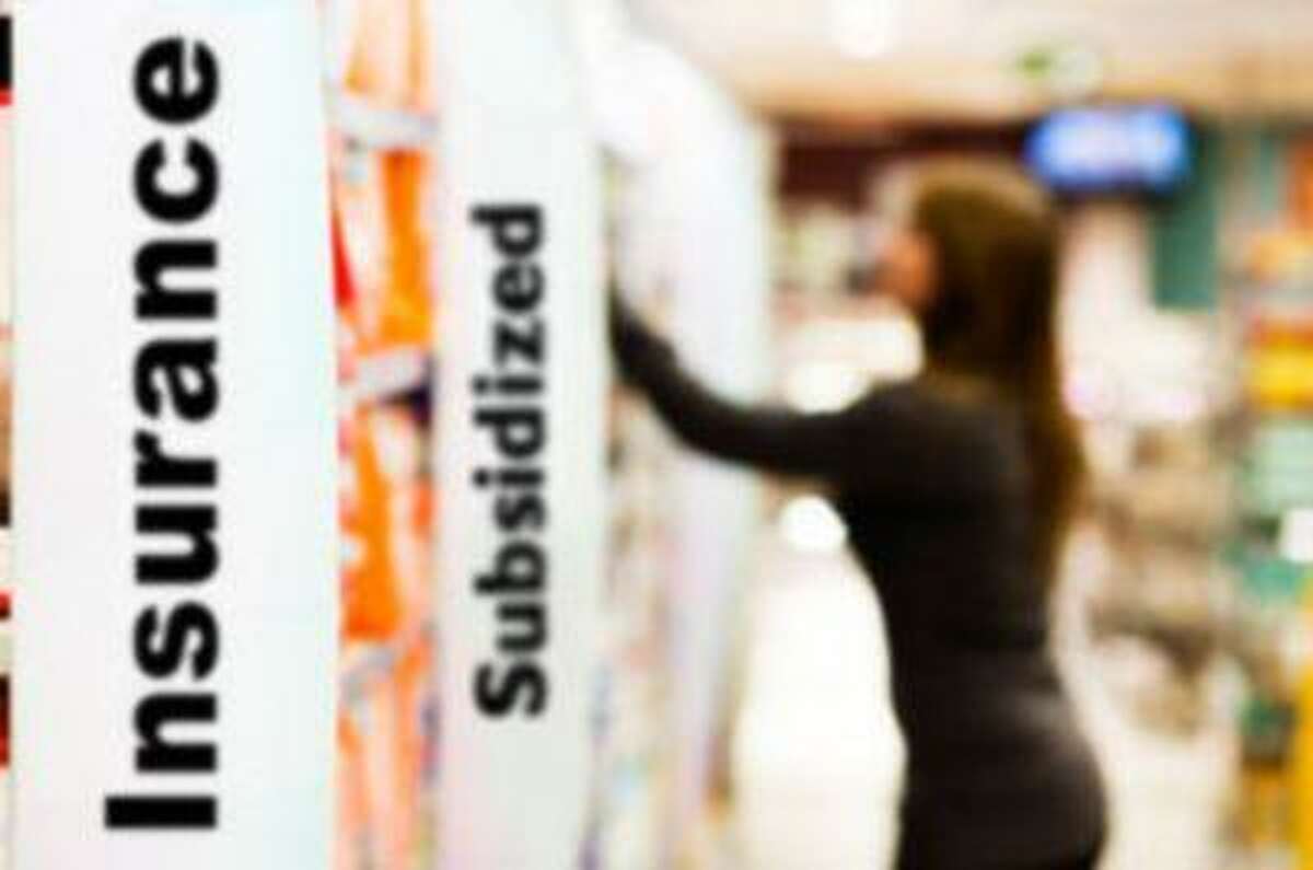 Woman reaches for something in a supermarket's toiletries aisle. Focus is on the big sign on the left that says "diapers". Camera: Canon EOS 1Ds Mark III.