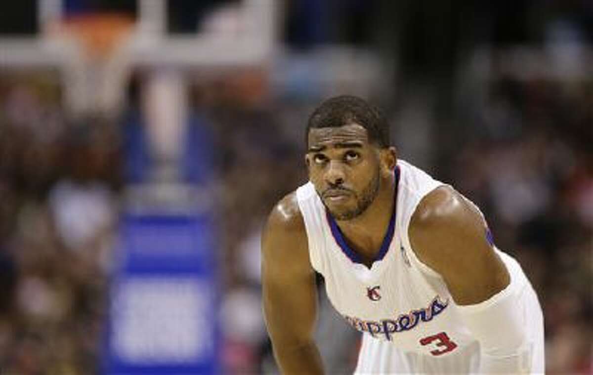 Los Angeles Clippers' Chris Paul looks on during the second half of an NBA basketball game against the Phoenix Suns on Monday, Dec. 30, 2013, in Los Angeles.