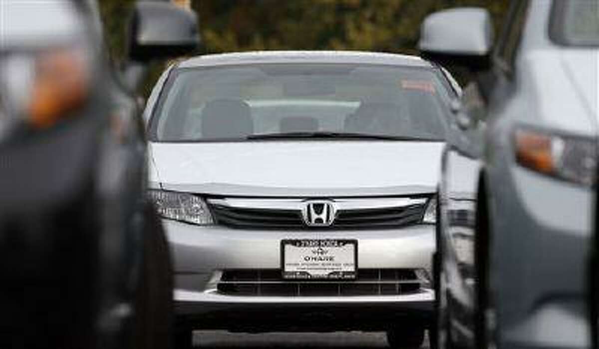In this Thursday, Oct. 4, 2012, photo, a Honda civic is seen outside of a Honda car dealership in Des Planines, Ill. Used cars have gotten more affordable, especially if you're looking for a small car or a hybrid. (AP Photo/Nam Y. Huh)