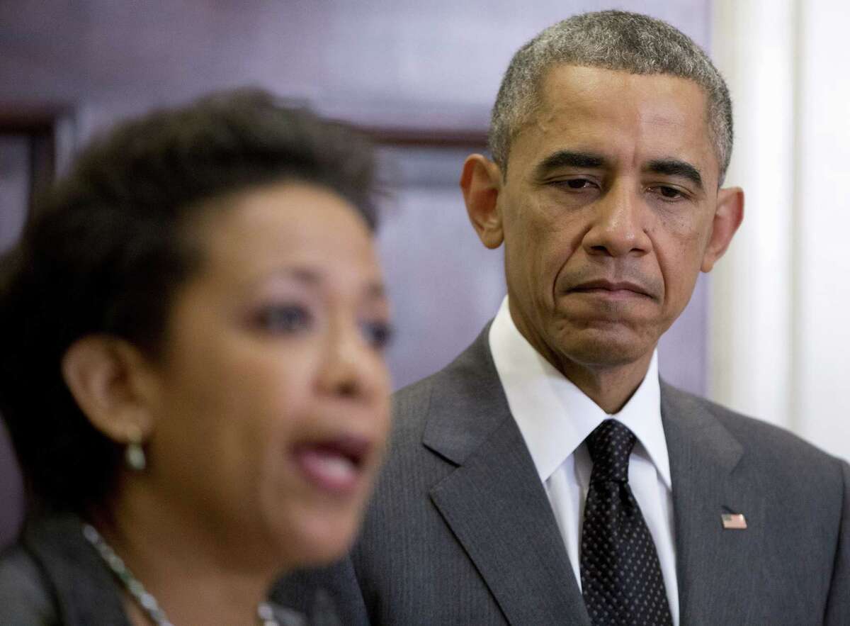 President Barack Obama listens as US Attorney Loretta Lynch speaks, in the Roosevelt Room of the White House in Washington, Saturday, Nov. 8, 2014, where the president announced that he will nominate Lynch to replace Attorney General Eric Holder. (AP Photo/Carolyn Kaster)