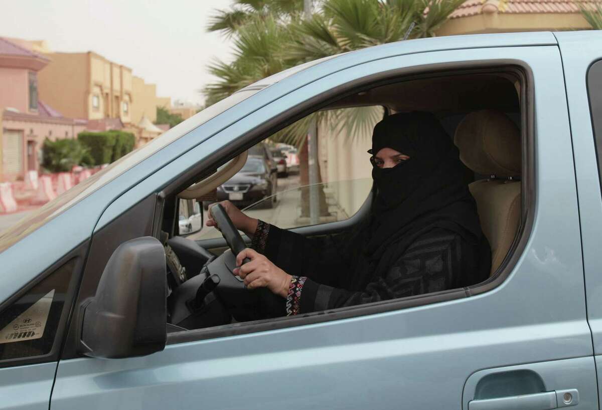FILE - In this file photo taken Saturday, March 29, 2014, Aziza Yousef drives a car in Riyadh, Saudi Arabia, as part of a campaign to defy Saudi Arabia's ban on women driving. A Saudi official said Friday, Nov. 7, that the kingdom's advisory council has recommended to the government for the first time the partial lifting of the ban on women driving, but with conditions: Only women over 30, only during the day, and no makeup allowed while driving. (AP Photo/Hasan Jamali, File)