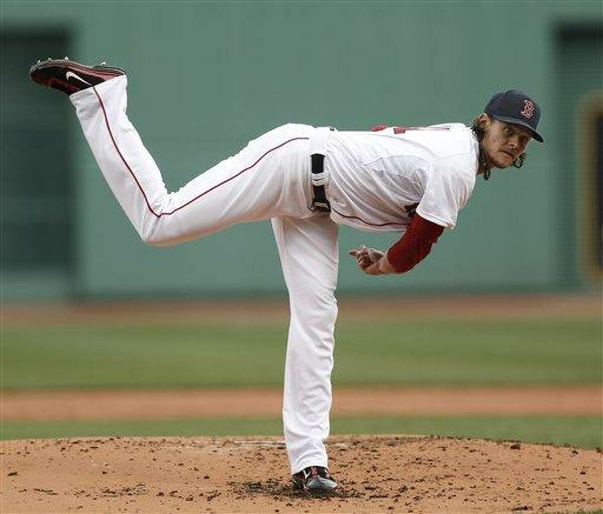 Boston Red Sox starting pitcher Clay Buchholz delivers against the Tampa Bay Rays during the first inning of a baseball game at Fenway Park in Boston Sunday, April 14, 2013. (AP Photo/Winslow Townson)