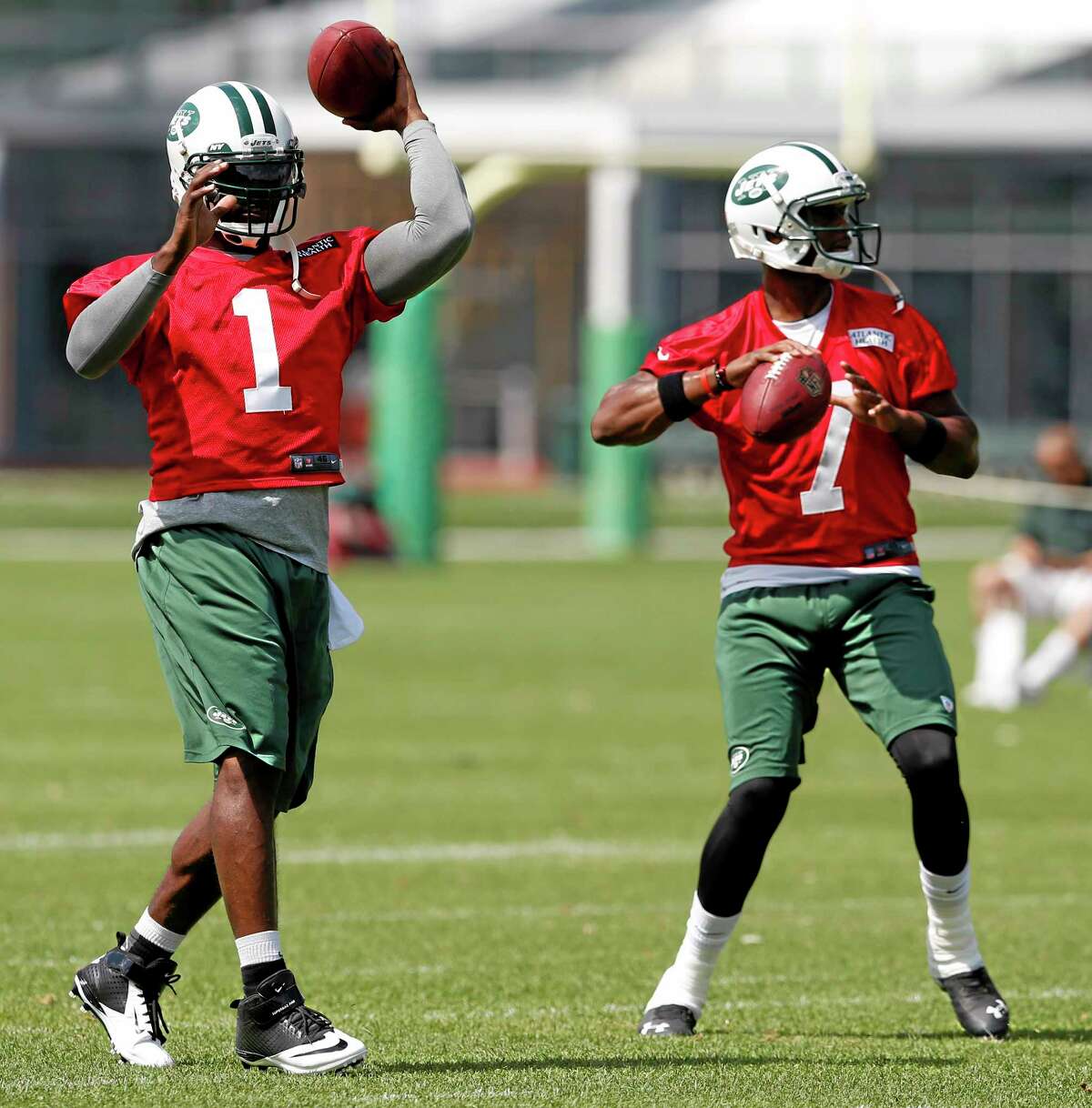 This June 4 file photo shows New York Jets quarterbacks Michael Vick, left, and Geno Smith working out during an OTAs in Florham Park, N.J.