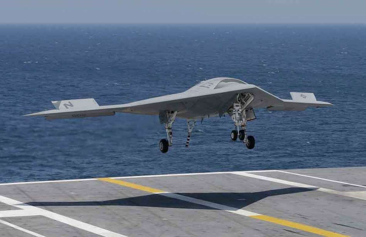 A X47-B Navy drone approaches the deck as it lands aboard the nuclear aircraft carrier USS George H. W. Bush off the Coast of Virginia Wednesday, July 10, 2013. It is the first landing by a drone on a Navy carrier. (AP Photo/Steve Helber)