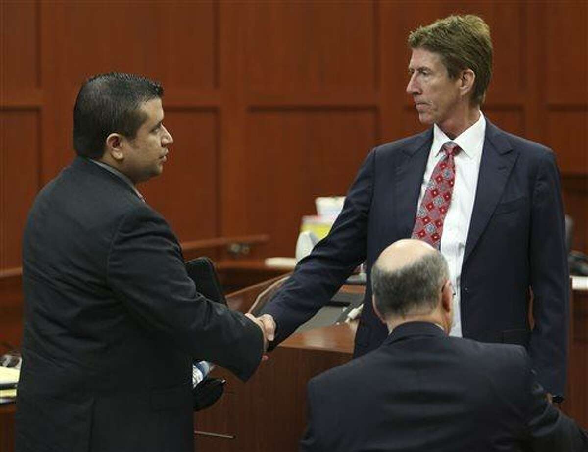 George Zimmerman, left, shakes hands with his defense attorney Mark O'Mara during a recess in his trial in Seminole circuit court in Sanford, Fla. Wednesday, July 10, 2013. Zimmerman has been charged with second-degree murder for the 2012 shooting death of Trayvon Martin. (AP Photo/Orlando Sentinel, Gary W. Green, Pool)