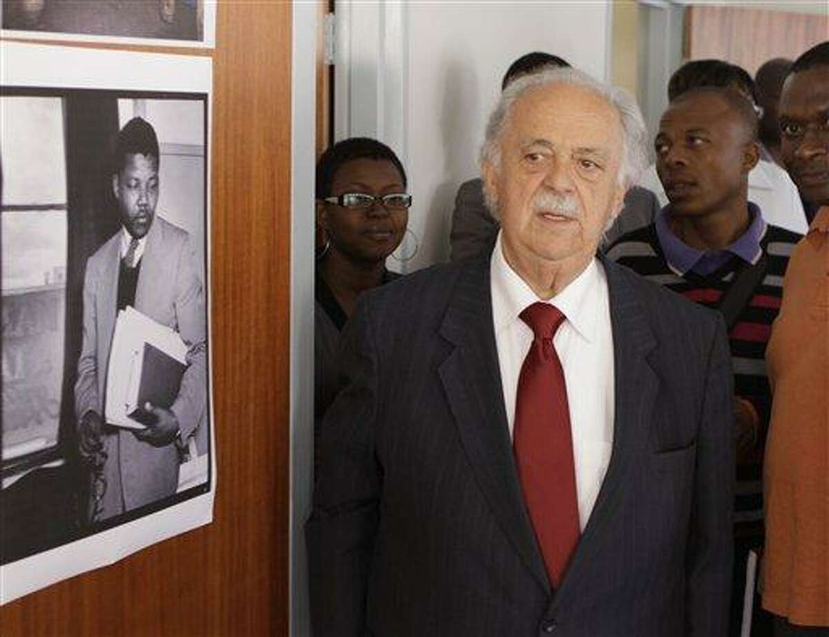 FILE - In this Wednesday May 4, 2011, file photo, Advocate George Bizos tours the building where Nelson Mandela and Oliver Tambo had a historic law office in Johannesburg. Bizos, a member of the legal team that defended Mandela and others at the Rivonia trial, said Machel invited him to see Mandela in the hospital last month. But the visit was canceled when the health of his old friend deteriorated. (AP Photo/Denis Farrell, File)