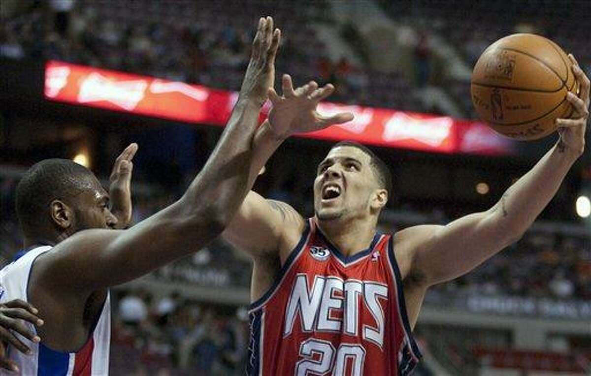 New Jersey Nets' Jordan Williams (20) goes to the basket against Detroit Pistons' Jason Maxiell in the first half of an NBA basketball game Friday, Feb. 10, 2012, in Auburn Hills, Mich. (AP Photo/Duane Burleson)