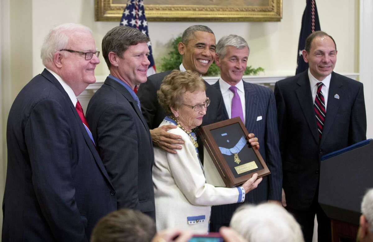 President Barack Obama stands with Helen Loring Ensign, 85, from Palm Desert, Calif., after awarding the Medal of Honor posthumously to Army First Lt. Alonzo H. Cushing for conspicuous gallantry during a ceremony in the East Room of the White House in Washington on Nov. 6. With them, from left to right, are Rep. Jim Sensenbrenner, R-Wis., Rep. Ron Kind, D-Wis., Army Secretary John McHugh and Veterans Affairs Secretary Robert McDonald.
