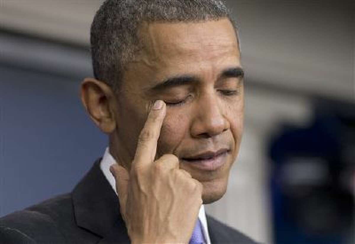 President Barack Obama pauses to rub his eye as he speaks about his signature health care law, Thursday, Nov. 14, 2013, in the Brady Press Briefing Room of the White House in Washington. Bowing to pressure, President Barack Obama intends to permit continued sale of individual insurance plans that have been canceled because they failed to meet coverage standards under the health care law, officials said Thursday.