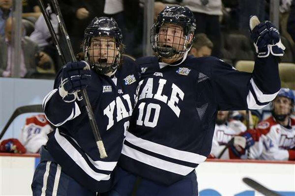 Yale forward Mitch Witek (10) celebrates his first-period goal with Carson Cooper (9) during an NCAA college hockey game against UMass Lowell in Pittsburgh, Thursday, April 11, 2013. (AP Photo/Gene Puskar)