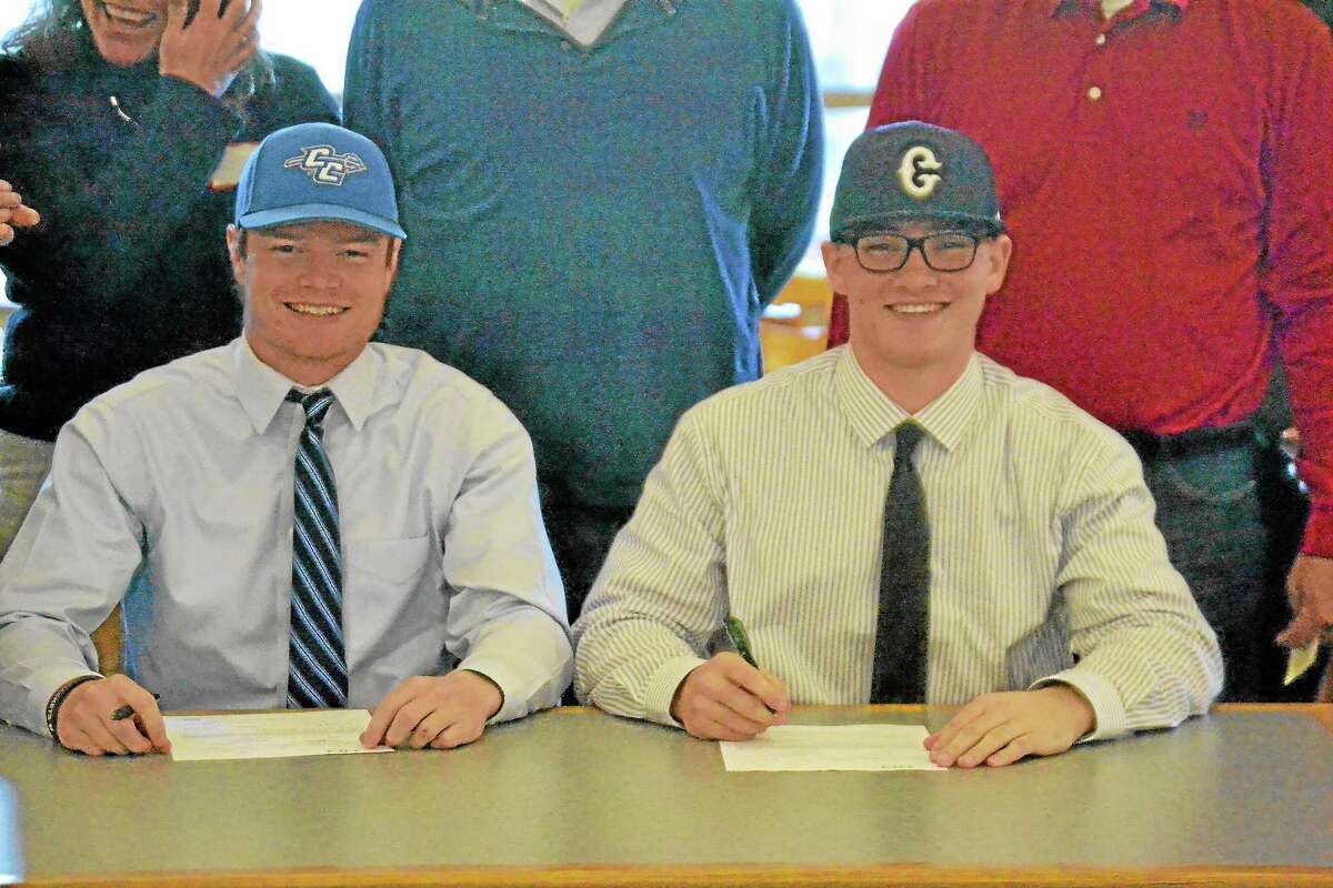 Northwestern’s John Lippincott (left) and Zach Risedorf (right) sign their National Letters of Intent in the Northwestern Regional School No. 7 media room on Wednesday. Lippincott will play at Central Connecticut State University and Risedorf will play at UConn next season.