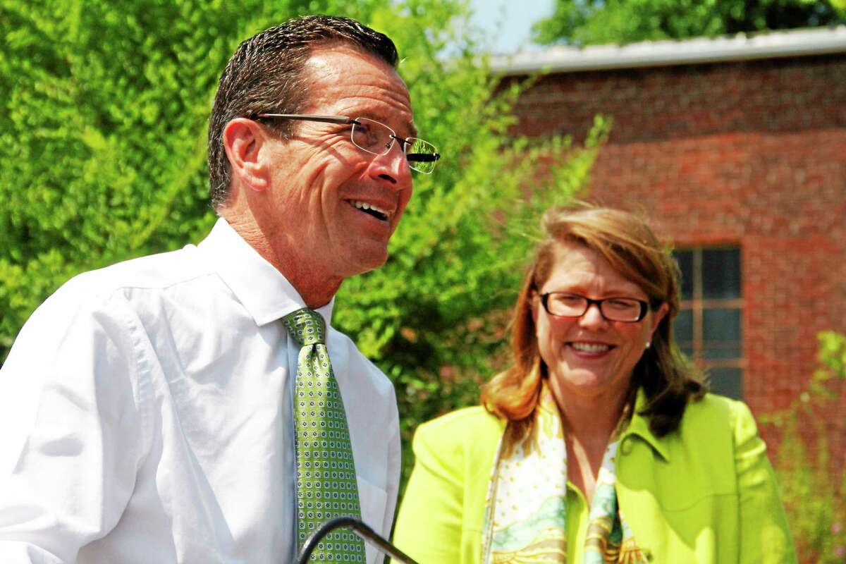 Gov. Dannel Malloy laughs as Winsted Mayor Marsha Sterling looks on in the background during a brief press conference announcing a $500,000 grant to help redevelop a site in the town on Friday in Winsted. Winsted was one of several municipalities in Litchfield County to receive the Small Town Economic Assistant Program grants.