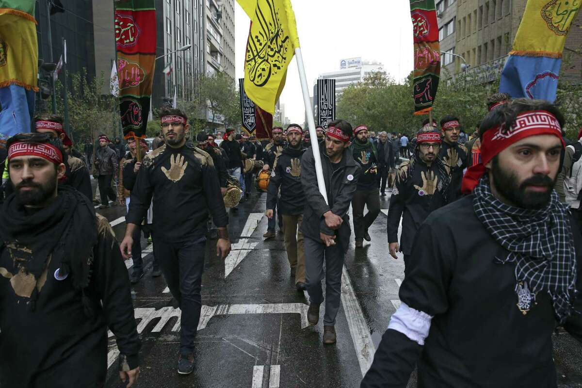 Iranians chant slogans during an anti-U.S. demonstration in front of the former U.S. Embassy, during Ashoura, when Muslim Shiites mark the death of 7th century Imam Hussein, in Tehran, Iran, Tuesday, Nov. 4, 2014. Thousands of Iranians chanted ìDown with Americaî at an anti-U.S. rally on Tuesday marking the anniversary of the 1979 takeover of the U.S. Embassy in Tehran, just days ahead of a key meeting between the two nationsí top diplomats over Iranís controversial nuclear program. (AP Photo/Vahid Salemi)