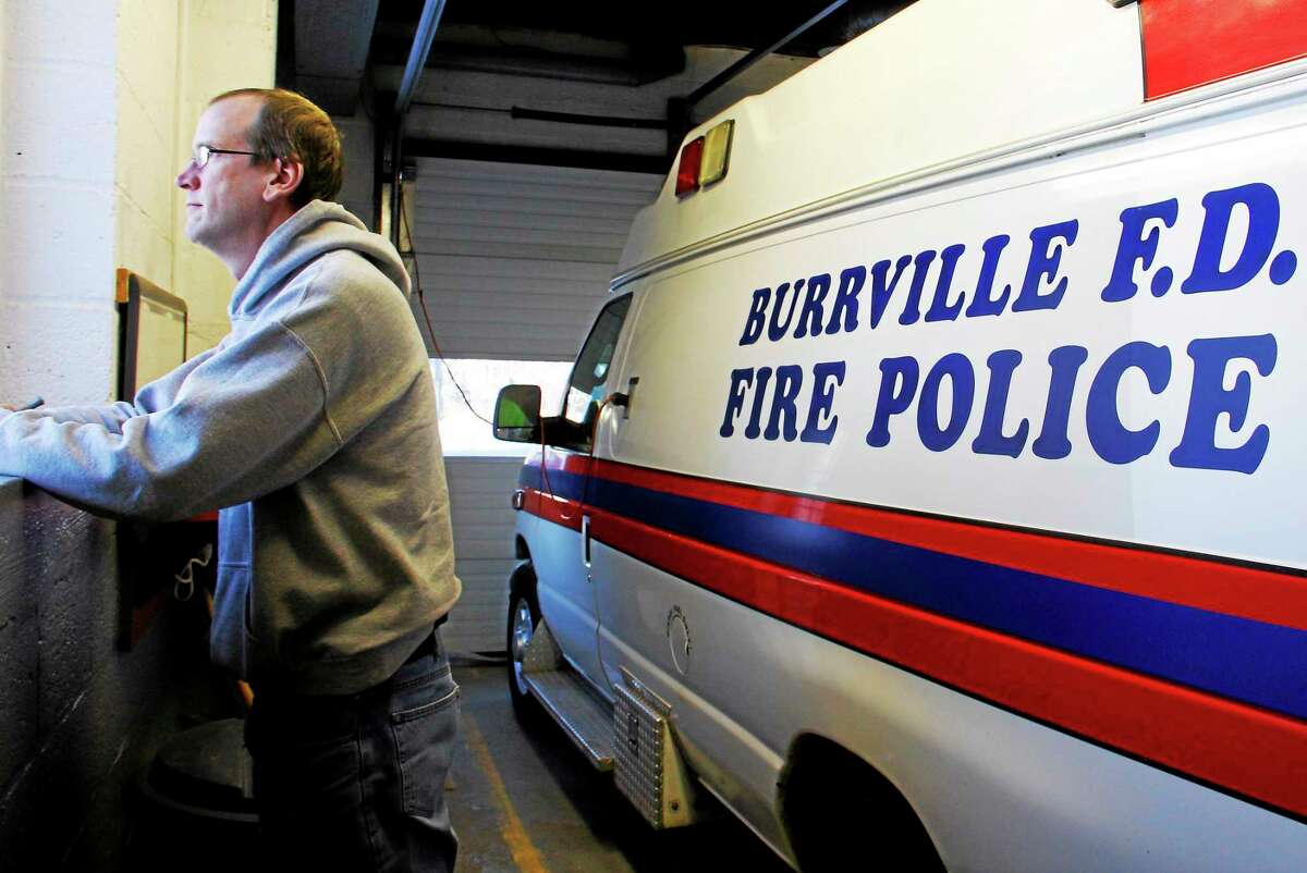 Burville Volunteer Fire Department Chief Jason Noad stands inside his fire station while looking outside a window on Thursday, Feb. 6, 2014, in Torrington. Noad said he’s a lifelong volunteer member and his grandfather once served in the position he now sits in.