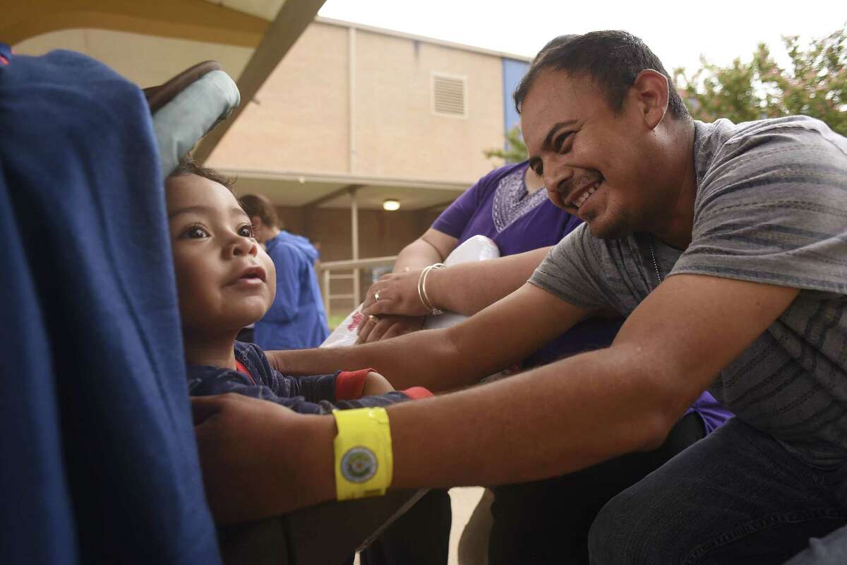 Carlos Rodriguez reaches for his 22-month-old son, Ian, at the Kazen Middle School evacuee shelter on Sunday, Aug. 27, 2017. A small number of Hurricane Harvey evacuees from Beaumont could be on their way San Antonio today, an official said Friday morning. Click through the images to see Harvey's impact on Southeast Texas.