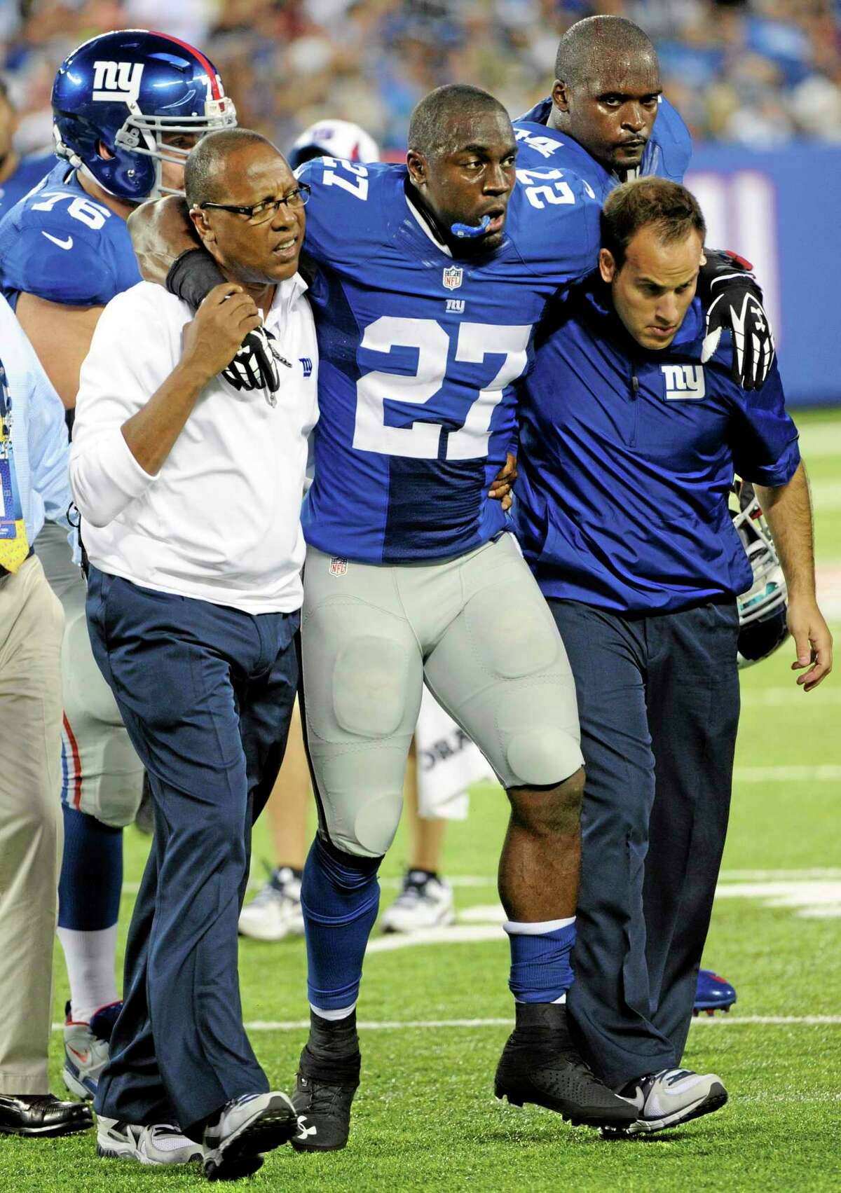 Trainers carry New York Giants safety Stevie Brown off the field after he was injured on a play during the first half of a preseason game against the New York Jets on Saturday in East Rutherford, N.J.