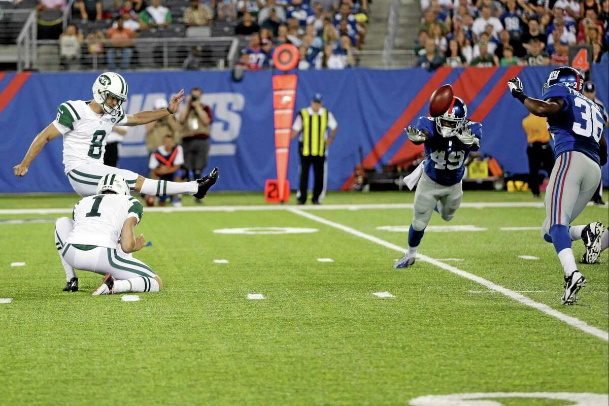 New York Jets place kicker Billy Cundiff kicks a field goal past the New York Giants’ Junior Mertile (49) to win the game during overtime of a preseason game on Saturday in East Rutherford N.J. The Jets won the game 24-21.