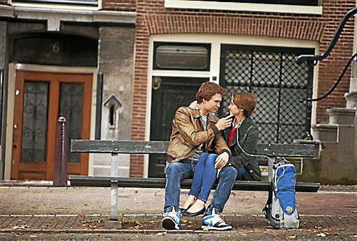 FILE - In this file image released by 20th Century Fox, Ansel Elgort, left, and Shailene Woodley appear in a scene from "The Fault In Our Stars." The city of Amsterdam isn't quite sure whether to blame fate or human error, but a bench upon which the star-crossed teenage lovers talk and kiss in the hit film "The Fault in Our Stars" is missing. The green bench that used to sit on the Leidsdegracht resembles hundreds of others around the city, and its absence went unnoticed for at least a month ? probably because unknown persons placed a large flower pot on the spot. (AP Photo/20th Century Fox, James Bridges, File)