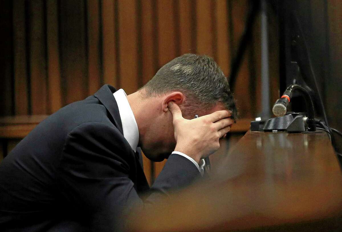 Oscar Pistorius holds his head in his hands during the testimony of a ballistics expert last week.