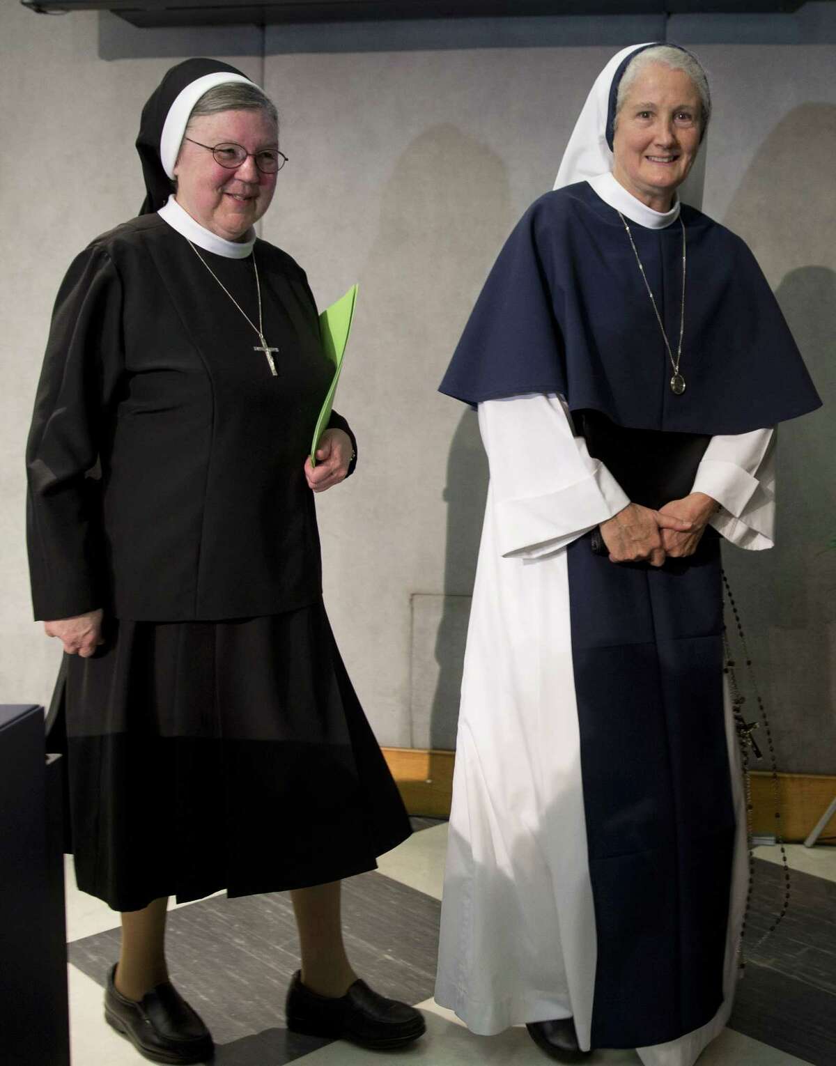 Mother Mary Clare Millea, left, and Sister Agnes Mary Donovan leave at the end of a press conference at the Vatican on Dec. 16, 2014. The Vatican went out of its way to mend fences with American religious sisters, thanking them for their selfless work caring for the poor, gently suggesting ways to survive amid a decline in numbers and promising to value their “feminine genius” more.