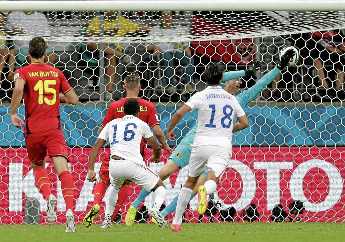 Belgium's goalkeeper Thibaut Courtois can not stop a shot by United States' Julian Green (16) as Green scores his side's first goal in extra time during the World Cup round of 16 soccer match between Belgium and the USA at the Arena Fonte Nova in Salvador, Brazil, Tuesday, July 1, 2014. (AP Photo/Marcio Jose Sanchez)