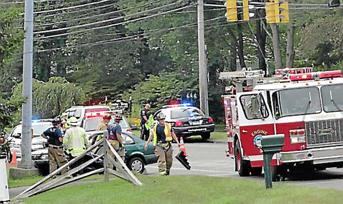 Firefighters and police at the scene of a two-car crash on New Harwinton Road on Monday.