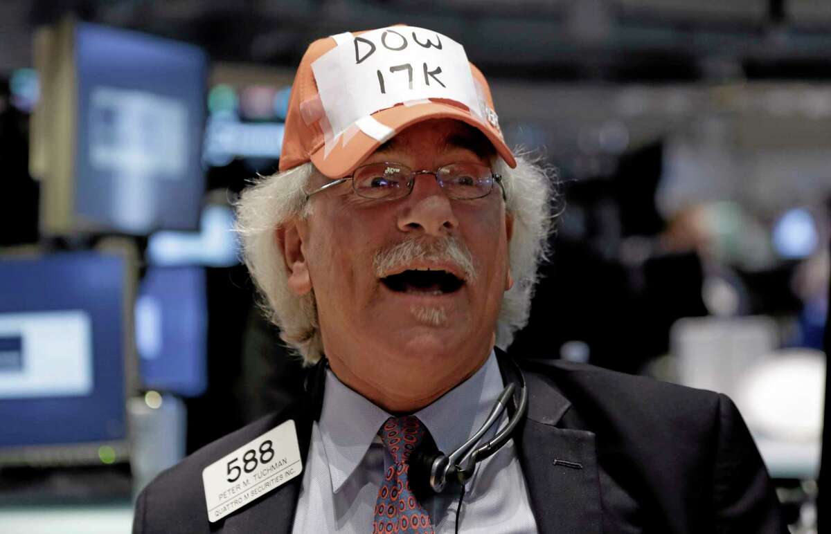 Trader Peter Tuchman jokes while wearing a handmade “Dow 17,000” cap as he works on the floor of the New York Stock Exchange Tuesday.
