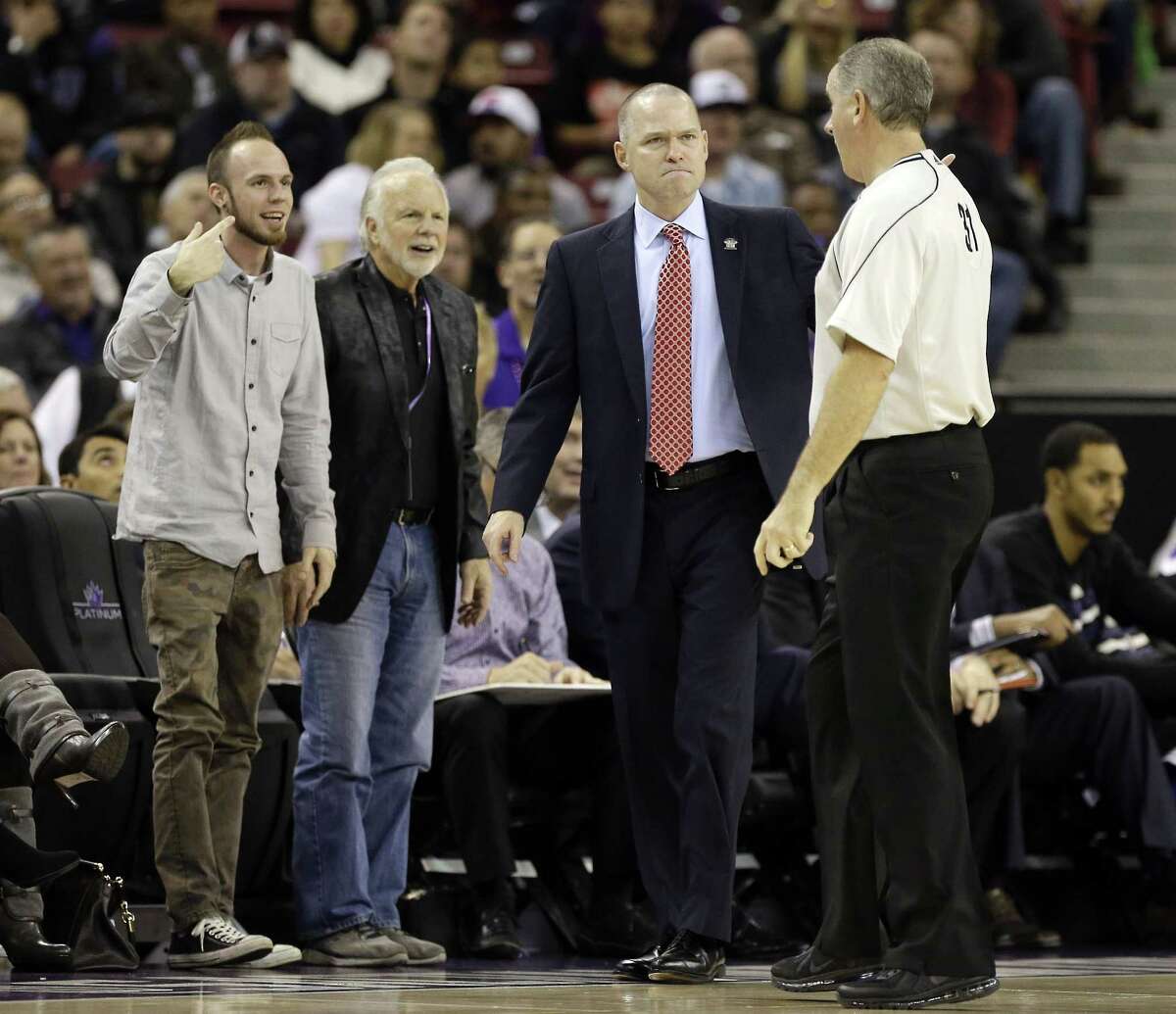 Official Scott Wall, right, explains a foul he called against Sacramento to Kings head coach Michael Malone, second from right, during the fourth quarter of a Dec. 2 game against the Toronto Raptors in Sacramento, Calif.