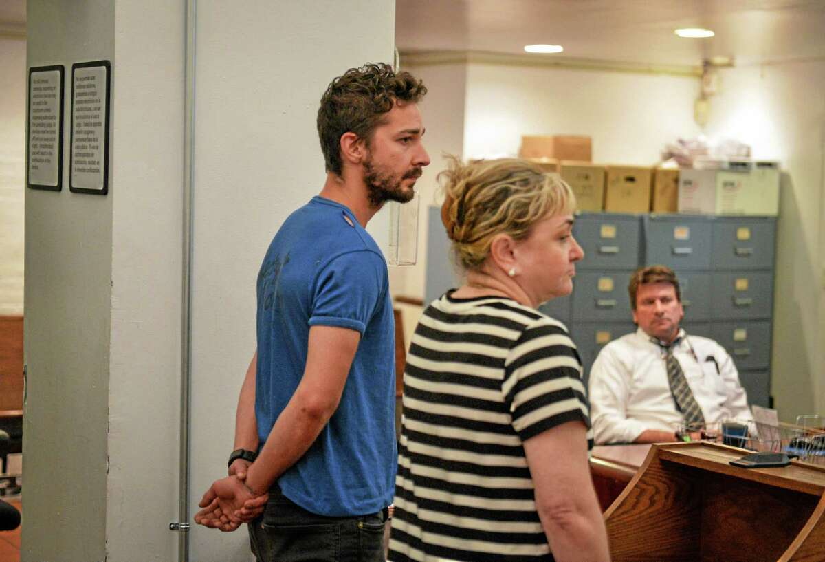 Shia LaBeouf, left, represented by a Legal Aid attorney, is arraigned in Midtown Community Court, in New York, Friday, June 27, 2014. LaBeouf was released from police custody Friday after he was escorted from a Broadway theater for yelling obscenities and continued to act irrationally while being arrested, authorities said. He's due back in court July 24. (AP Photo/Anthony DelMundo, NY Daily News, Pool)
