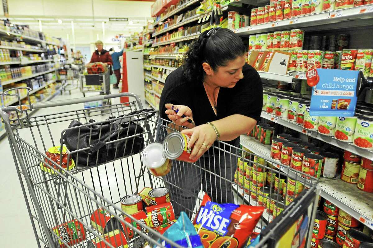 Jennifer Thomas, of New Haven, used a variety of coupons to cut her $240.25 shopping bill down to $54.35 to win a “Coupon Olympics” event at the Torrington Price Chopper Tuesday. All items purchased during the event will be donated to the Feed the Need organization.