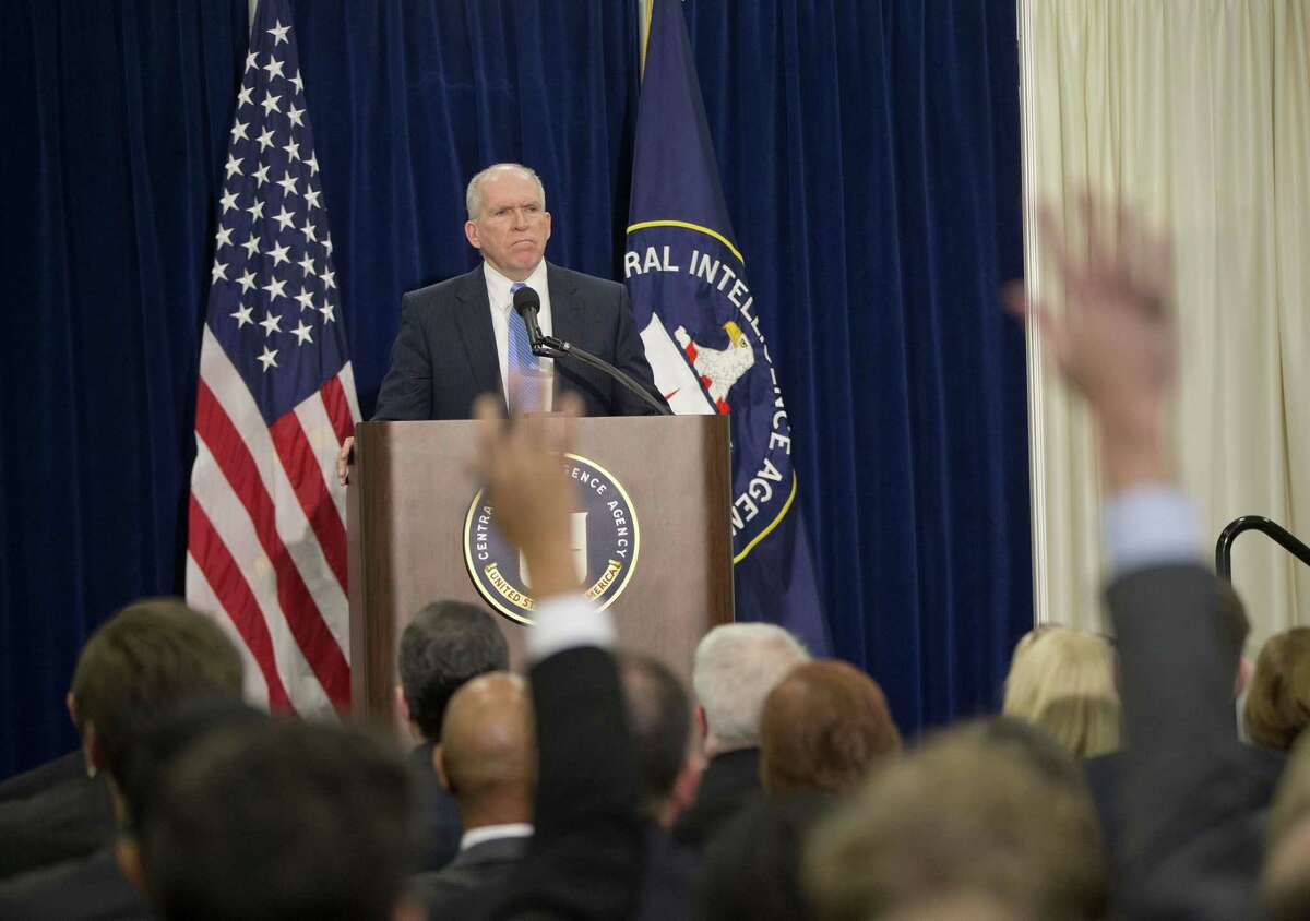 Members of the media raise their hands during CIA Director John Brennan’s news conference at CIA headquarters in Langley, Va., Thursday. Brennan was defending his agency from accusations in a Senate report that it used inhumane interrogation techniques against terrorist suspect with no security benefits to the nation.