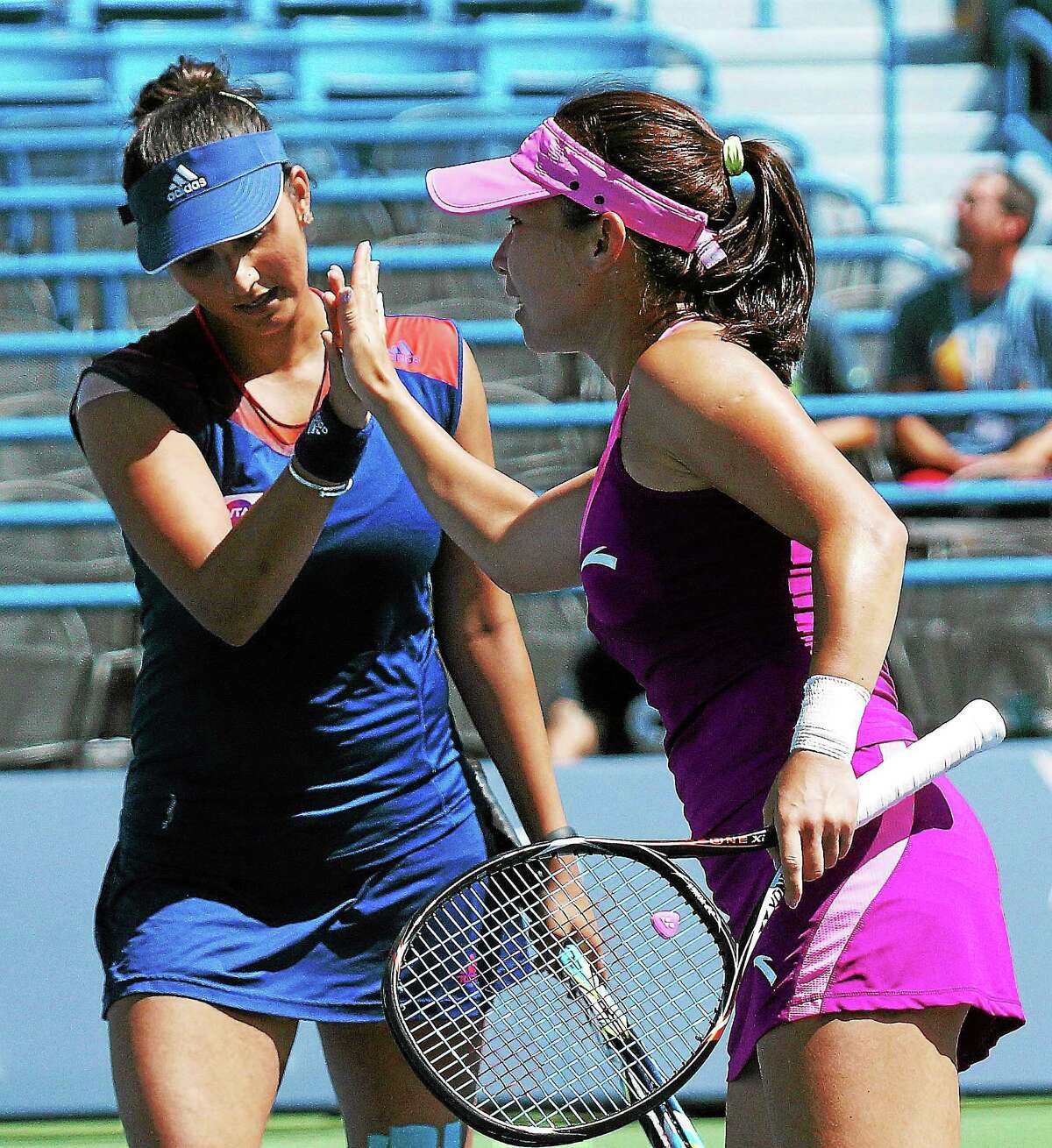 (Peter Casolino — New Haven Register) Sania Mirza, left, and Jie Zheng react as they beat Anabel Medina Garrigues and Katarina Srebotnik during the doubles finals.