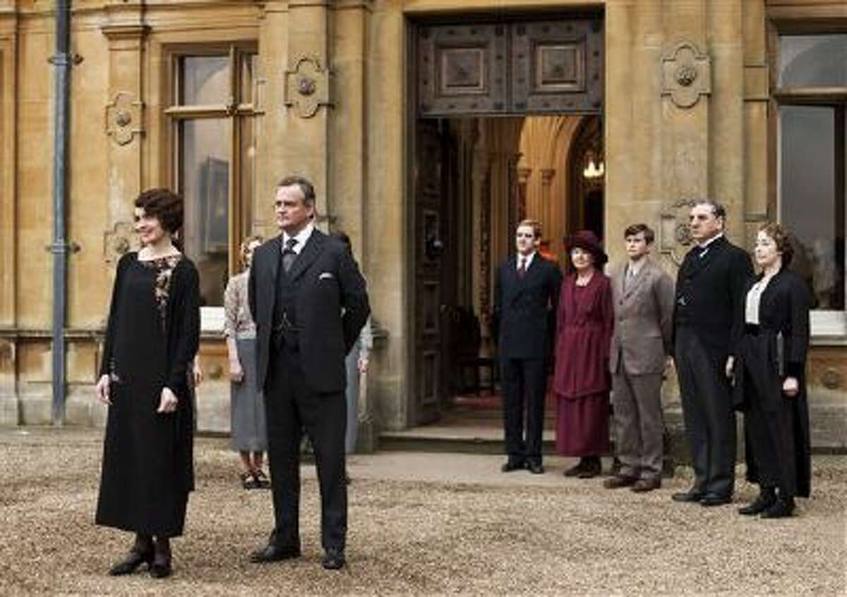 This undated publicity photo provided by PBS shows, from left, Elizabeth McGovern as Lady Grantham, Hugh Bonneville as Lord Grantham, Dan Stevens as Matthew Crawley, Penelope Wilton as Isobel Crawley, Allen Leech as Tom Branson, Jim Carter as Mr. Carson, and Phyllis Logan as Mrs. Hughes, from the TV series, "Downton Abbey."