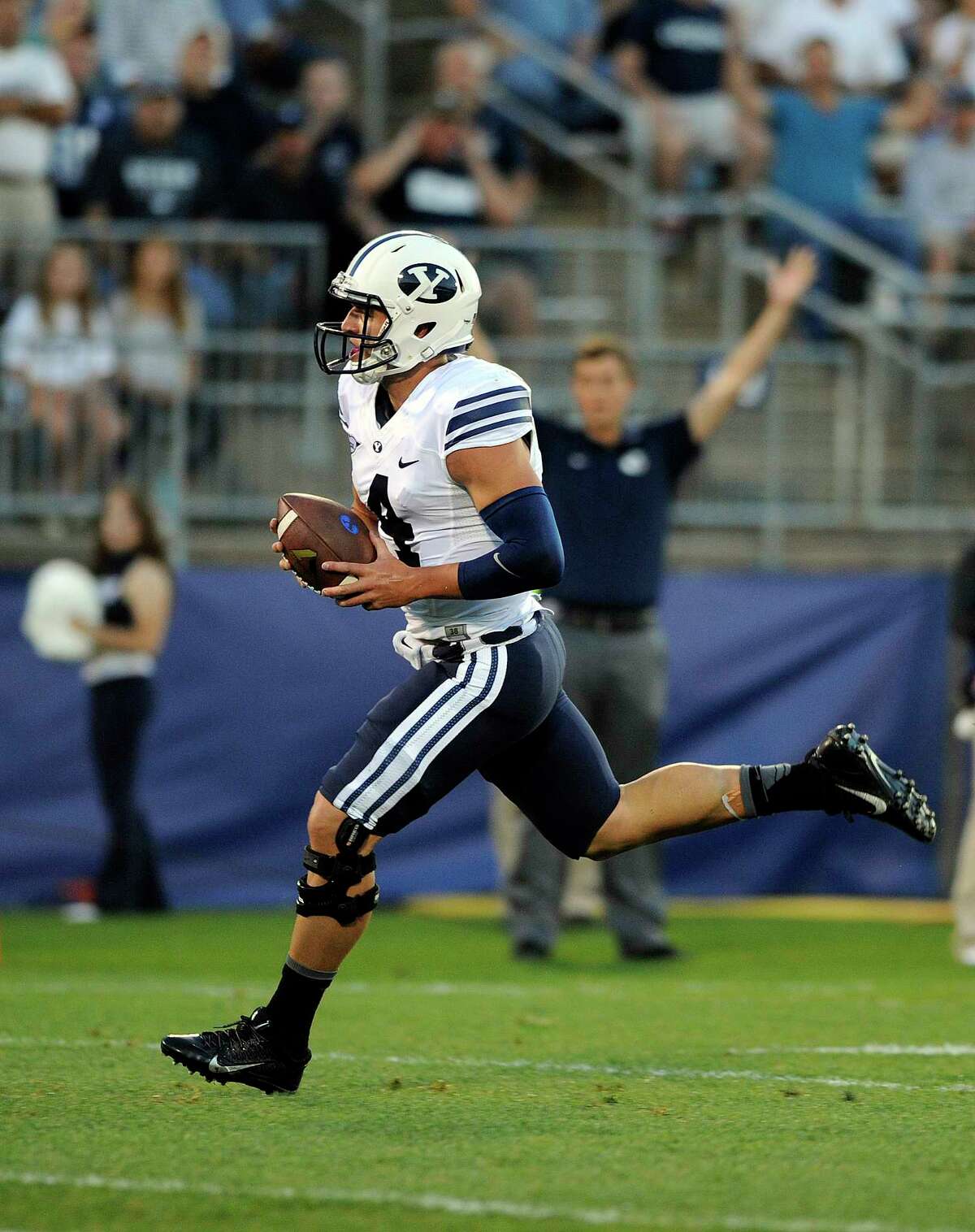 BYU quarterback Taysom Hill (4) runs for a touchdown during the Cougars’ 35-10 win over UConn on Friday night at Rentschler Field in East Hartford.