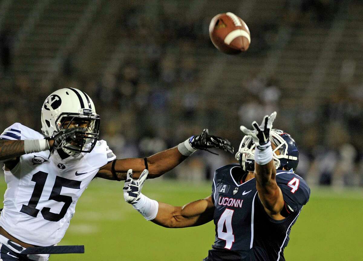 BYU cornerback Michael Davis (15) covers Connecticut wide receiver Deshon Foxx (4) during the second half of an NCAA college football game in East Hartford, Conn., Friday, Aug. 29, 2014. The pass was incomplete and BYU won the game 35-10. (AP Photo/Fred Beckham)