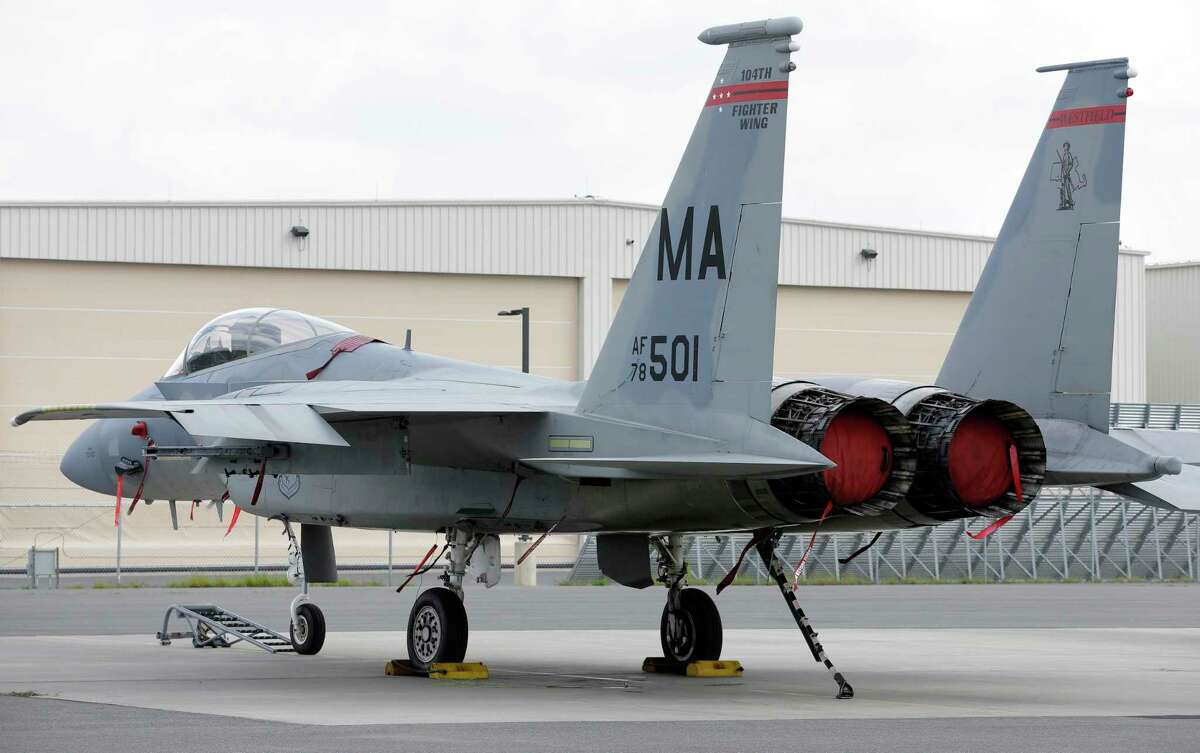 FILE - A Massachusetts Air National Guard F-15C fighter aircraft sits near a hangar at Barnes Air National Guard Base, in Westfield, Mass., Wednesday, Aug. 27, 2014 file photo. (AP Photo/Steven Senne, File)