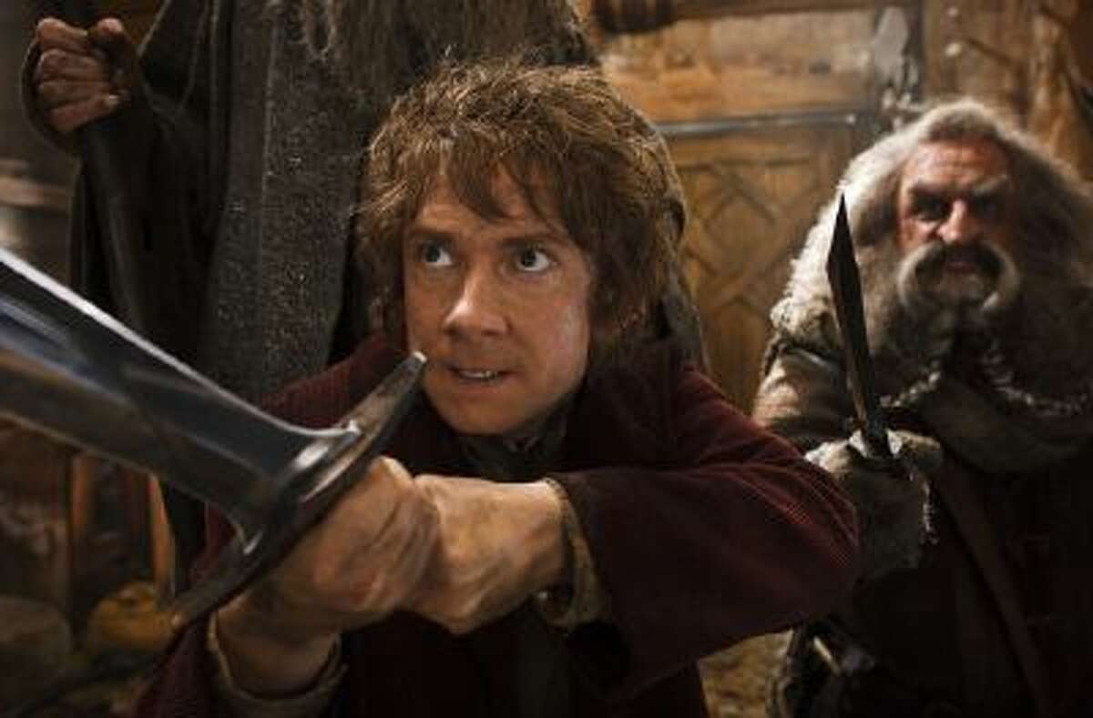 This image released by Warner Bros. Pictures shows Martin Freeman, left, and John Callen in a scene from "The Hobbit: The Desolation of Smaug."