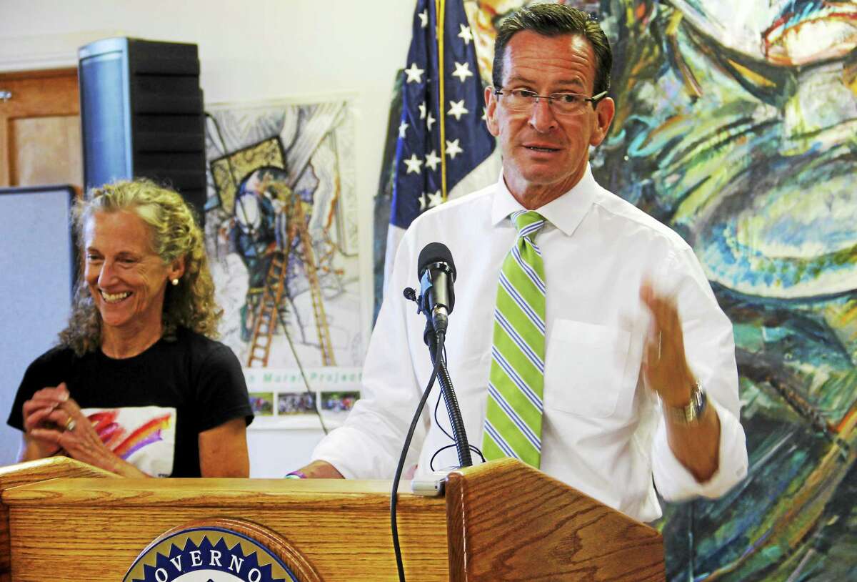 Gov. Dannel Malloy talks about the American Mural Project next to the project’s leader, Ellen Griesediesk Friday in Winsted. Malloy said the state could offer a $1 million matching grant if the project is able to raise $1.4 million to complete the project, which is about 80 percent done.