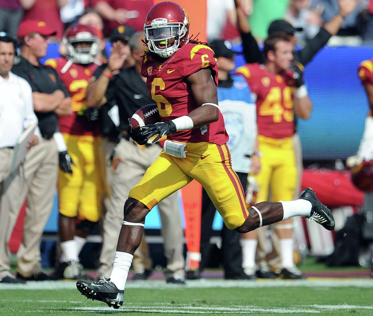 In this Oct. 26, 2013 file photo, Southern California safety Josh Shaw recovers a Utah fumble in a game in Los Angeles.