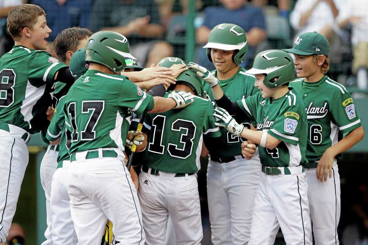 Westport, Conn.'s Tatin llamas (13) is greeted by teammates after hitting a two-run home run during the second inning of an elimination baseball game against Sammamish, Wash. at the Little League World Series tournament, Friday, Aug. 23, 2013, in South Williamsport, Pa. (AP Photo/Matt Slocum)
