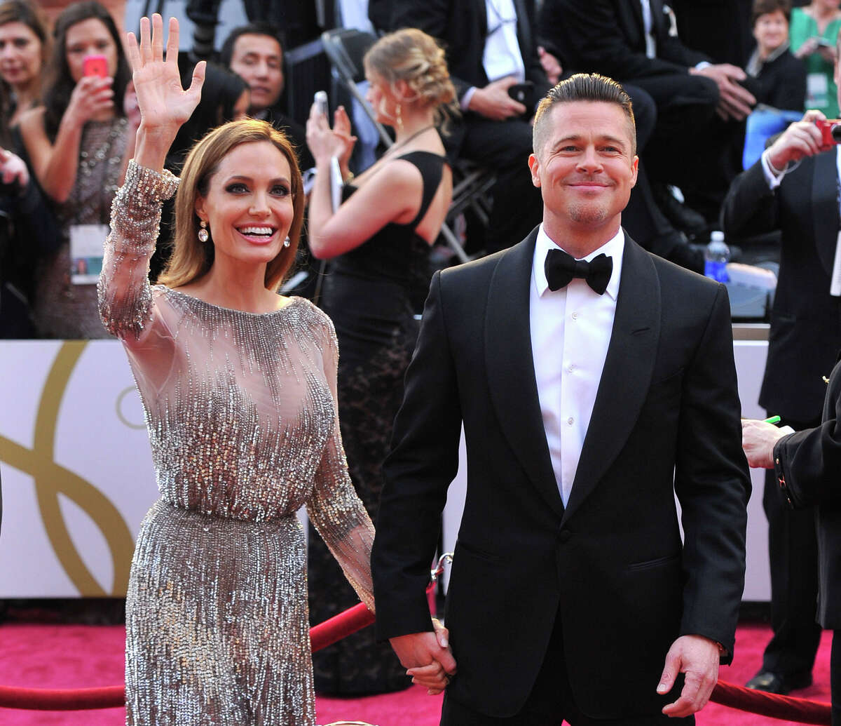 FILE - In this Sunday, March 2, 2014, file photo, Angelina Jolie, left, and Brad Pitt arrive at the Oscars at the Dolby Theatre in Los Angeles. Jolie and Pitt were married Saturday, Aug. 23, 2014, in France, according to a spokesman for the couple. (Photo by Vince Bucci/Invision/AP, File)