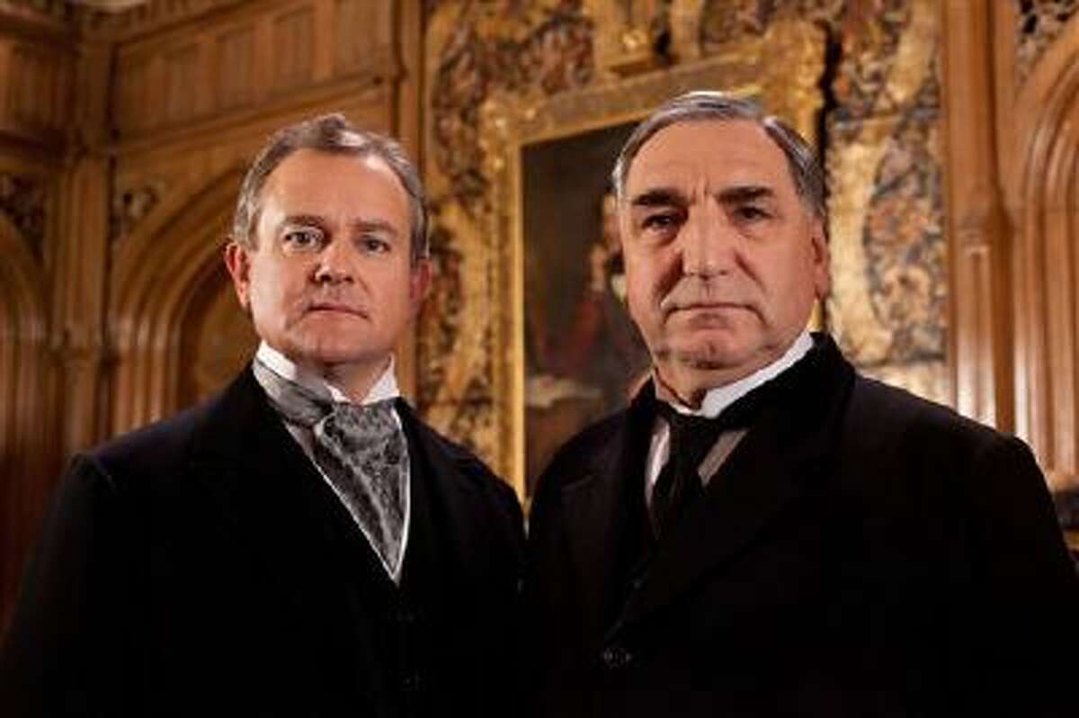 This undated file publicity image provided by PBS shows Hugh Bonneville as Lord Grantham, left, and Jim Carter as Mr. Carson from the popular series "Downton Abbey." The fourth season of "Downton Abbey" will debut Sunday, Jan 5, 2014.