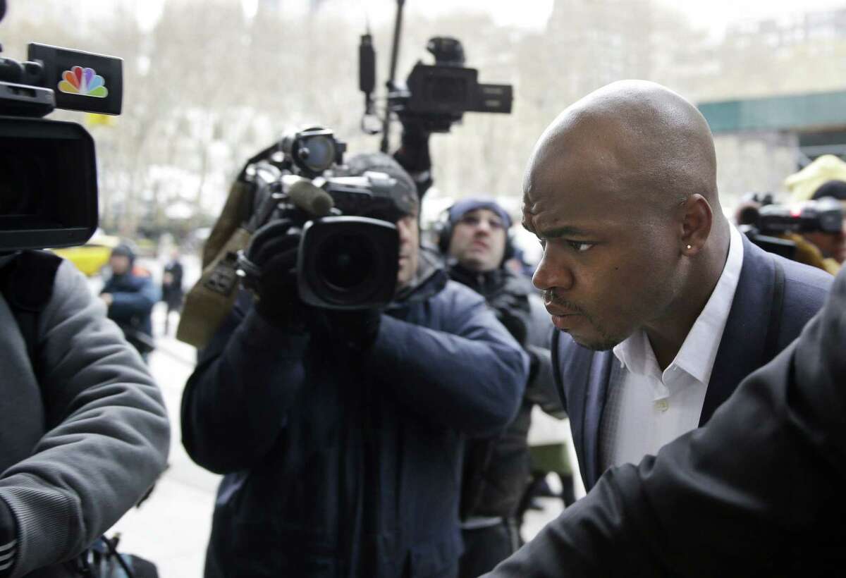 Minnesota Vikings running back Adrian Peterson arrives for a hearing for the appeal of his suspension in New York on Dec. 2.