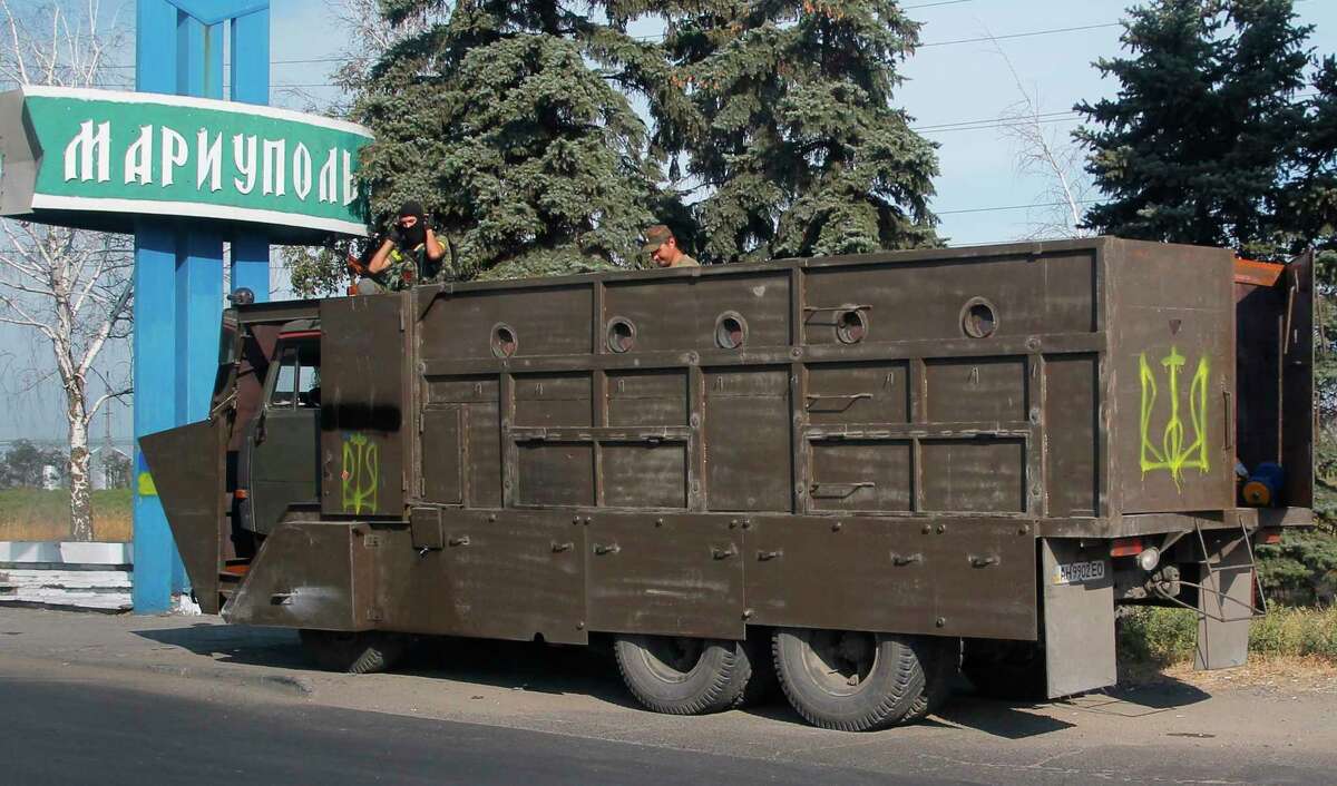 Armored truck with Ukrainian forces guard at a checkpoint in the town of Mariupol, eastern Ukraine, Thursday, Aug. 28, 2014. Ukraine's president Petro Poroshenko called an emergency meeting of the nation's security council and canceled a foreign trip Thursday, declaring that "Russian forces have entered Ukraine," as concerns grew about the opening of a new front in the conflict. (AP Photo/Sergei Grits)